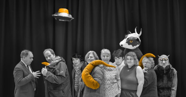 Group of WIT players on stage, including a cow and a tentacle